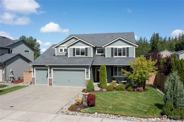 view of front of home with a garage and a front lawn