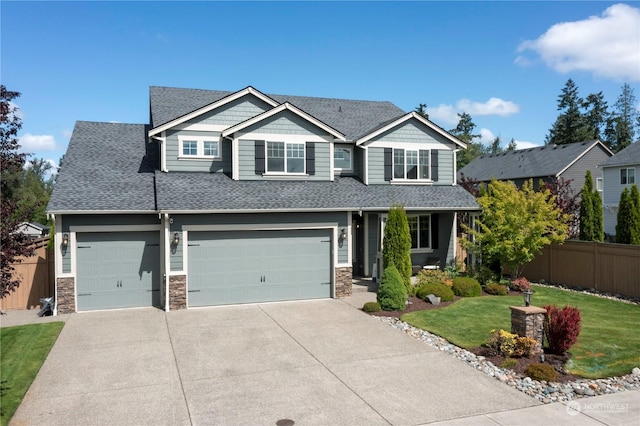 craftsman house featuring a garage and a front yard