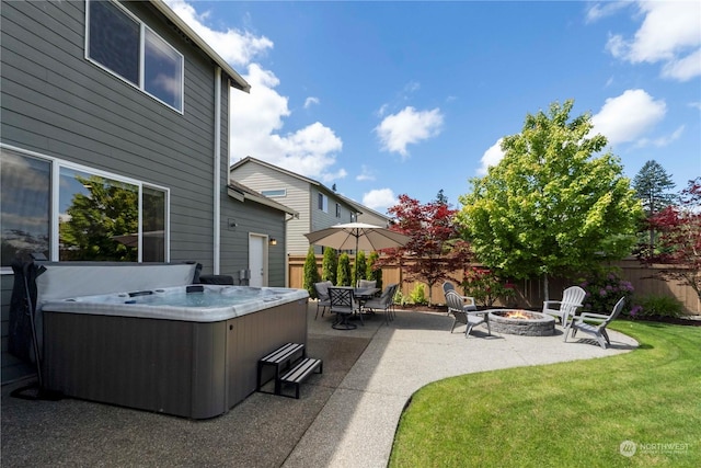 view of patio with a fire pit and a hot tub