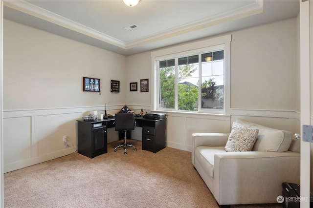 carpeted home office featuring a raised ceiling and ornamental molding