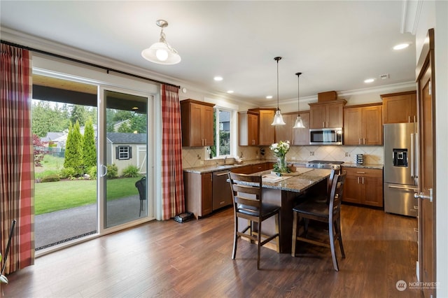 dining room with ornamental molding, dark wood-type flooring, and sink