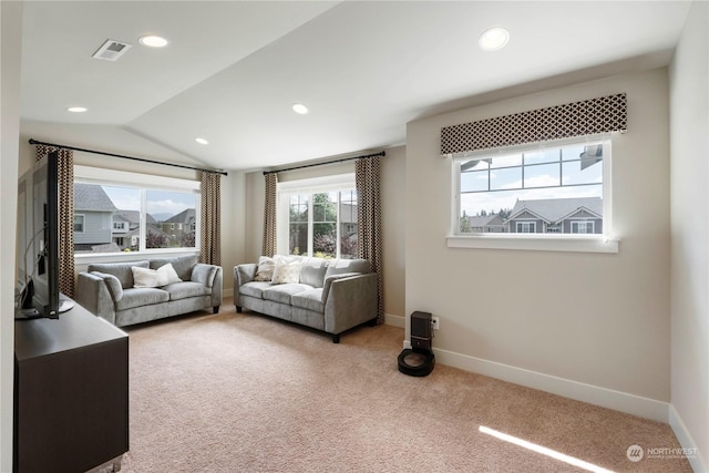 carpeted living room featuring vaulted ceiling