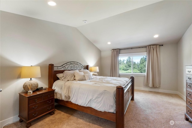 bedroom featuring lofted ceiling and light colored carpet