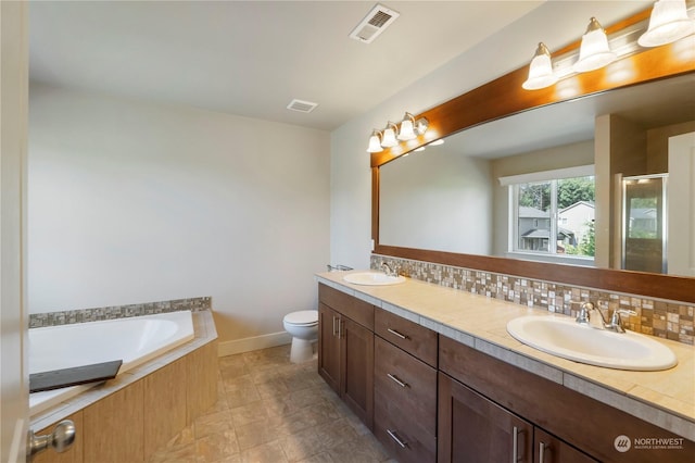 full bathroom featuring independent shower and bath, vanity, toilet, and decorative backsplash