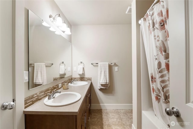 bathroom featuring vanity, shower / bathtub combination with curtain, and tile patterned flooring