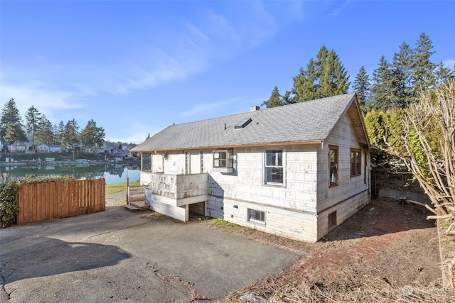 rear view of house with a water view