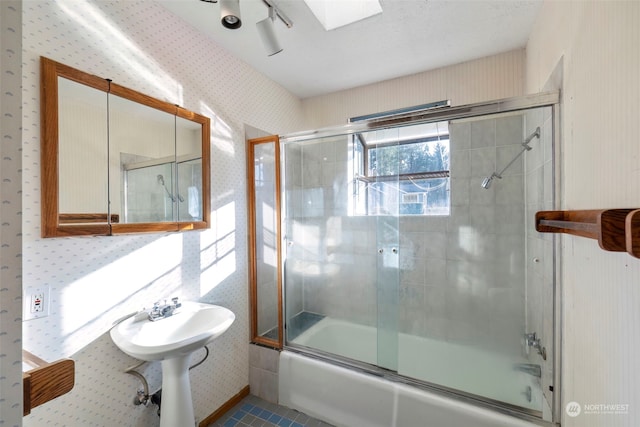 bathroom with a skylight and enclosed tub / shower combo