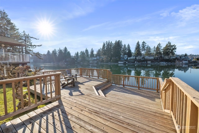 wooden terrace featuring a water view