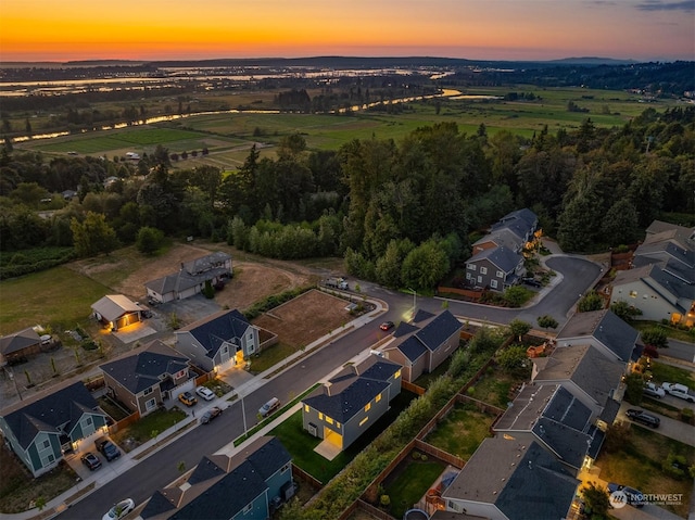 aerial view at dusk featuring a residential view