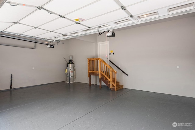 garage featuring strapped water heater and a garage door opener