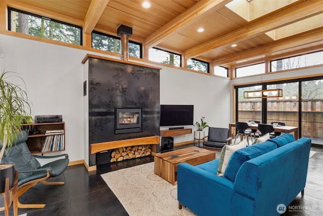 living room with a healthy amount of sunlight, wooden ceiling, baseboards, and beam ceiling