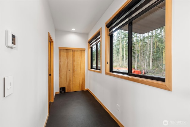 corridor with baseboards and recessed lighting