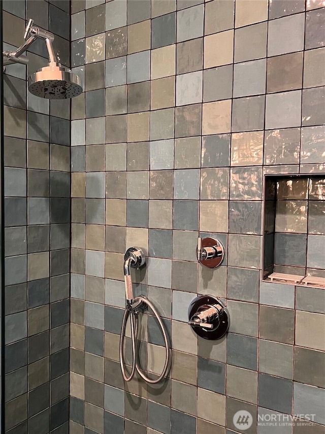 interior details with a tile shower