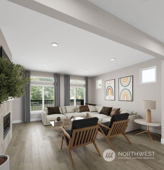 living room featuring hardwood / wood-style floors and a tile fireplace