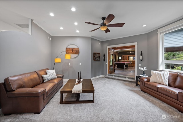 living room featuring crown molding, light carpet, and ceiling fan