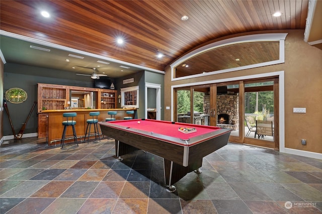 playroom with billiards, bar, a stone fireplace, wood ceiling, and vaulted ceiling