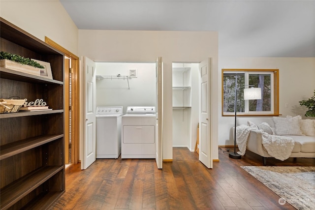 washroom with washing machine and clothes dryer and dark hardwood / wood-style flooring