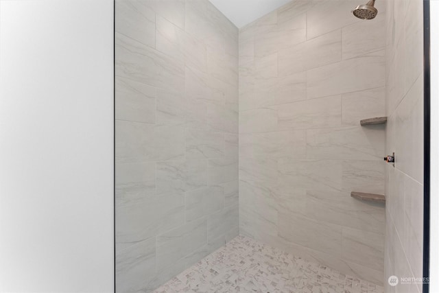 bathroom with tiled shower