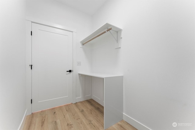 laundry area featuring light wood-type flooring