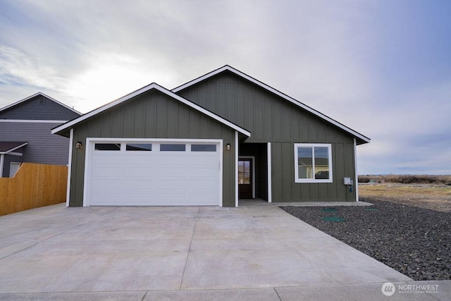 single story home with a garage, board and batten siding, driveway, and fence