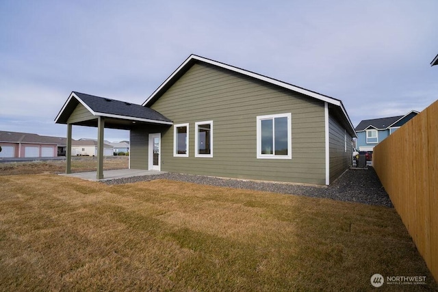 1300 Marina Dr Unit 12, Moses Lake, WA 98837 - rear view of property with a patio, a lawn, and fence