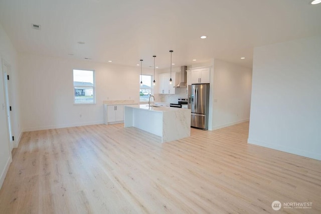1300 Marina Dr Unit 12, Moses Lake, WA 98837 - kitchen featuring light wood-type flooring, wall chimney exhaust hood, open floor plan, and stainless steel appliances
