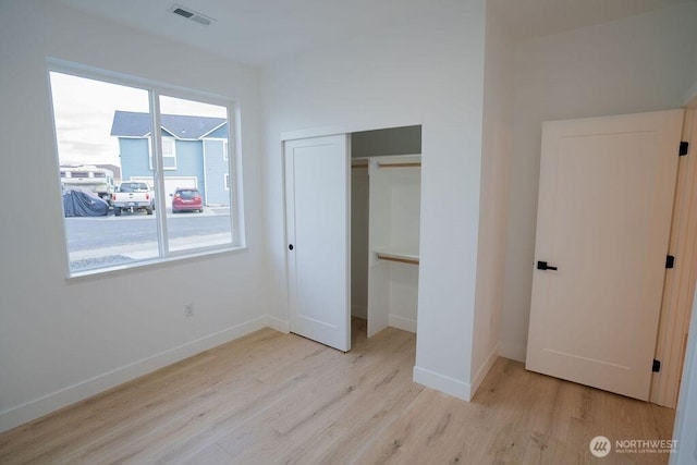 1300 Marina Dr Unit 12, Moses Lake, WA 98837 - unfurnished bedroom with visible vents, baseboards, a closet, and wood finished floors