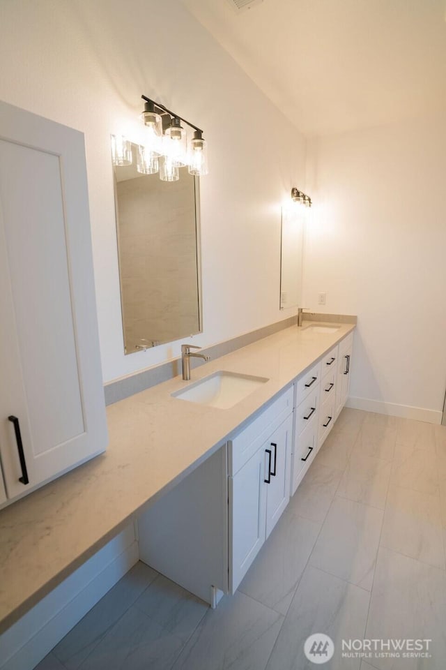 1300 Marina Dr Unit 12, Moses Lake, WA 98837 - bathroom featuring a sink, baseboards, marble finish floor, and double vanity