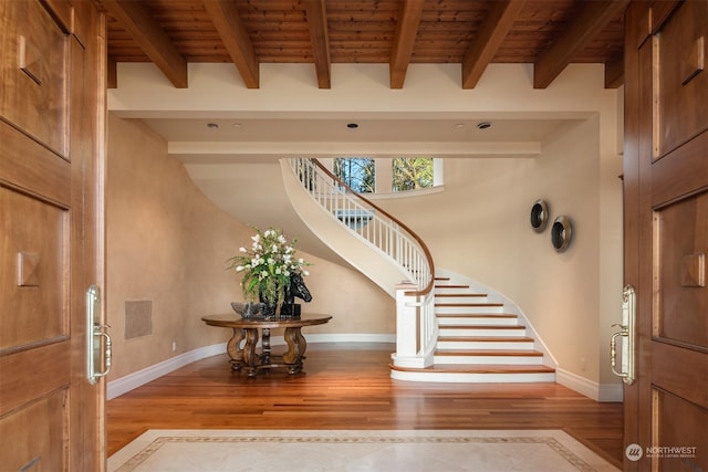 entryway with wooden ceiling, light hardwood / wood-style floors, and beamed ceiling