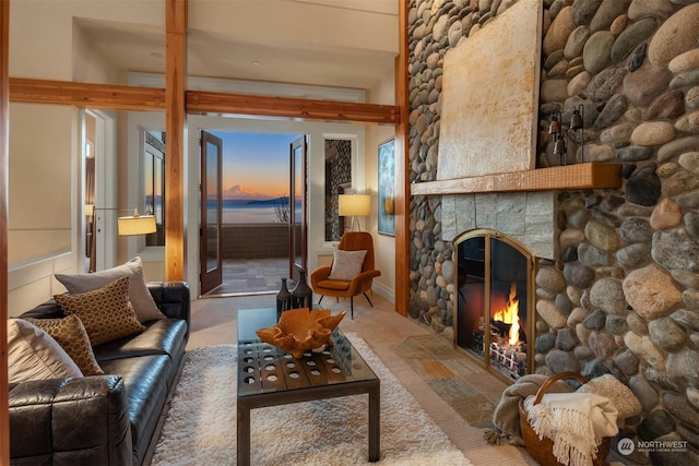 living room with a stone fireplace