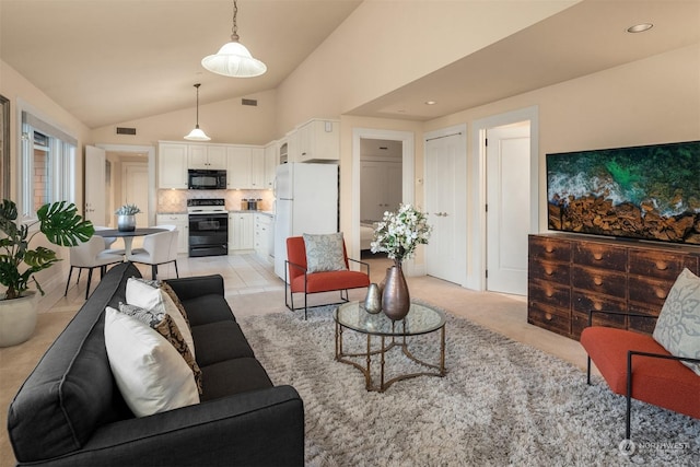 living room featuring light colored carpet and high vaulted ceiling