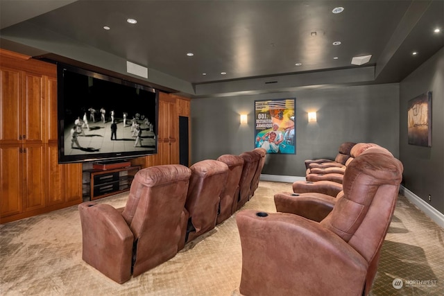 carpeted home theater room featuring a tray ceiling