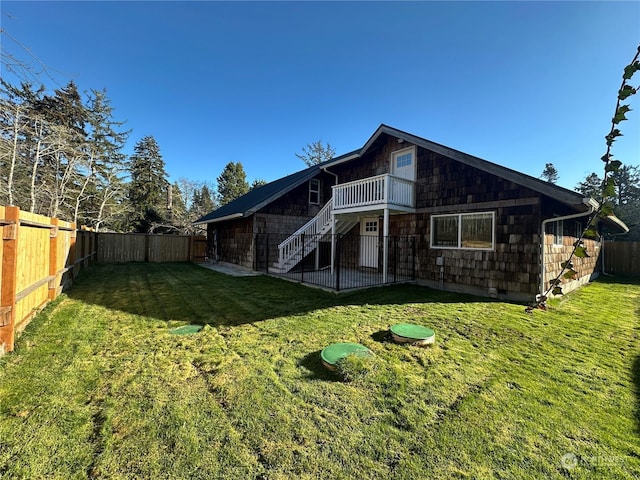 rear view of property with a yard