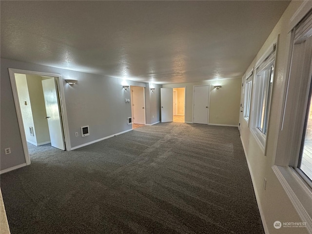 unfurnished room featuring dark carpet