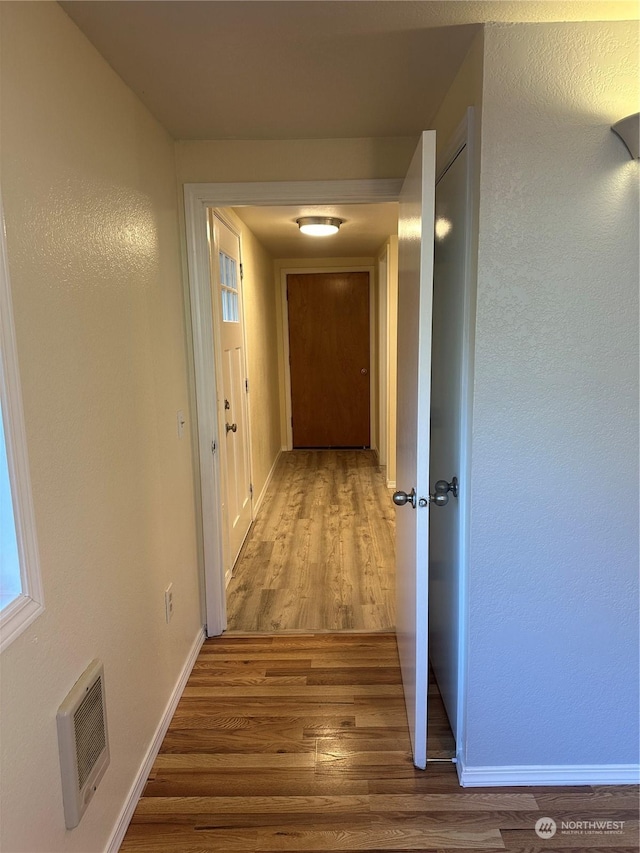 hall with wood-type flooring