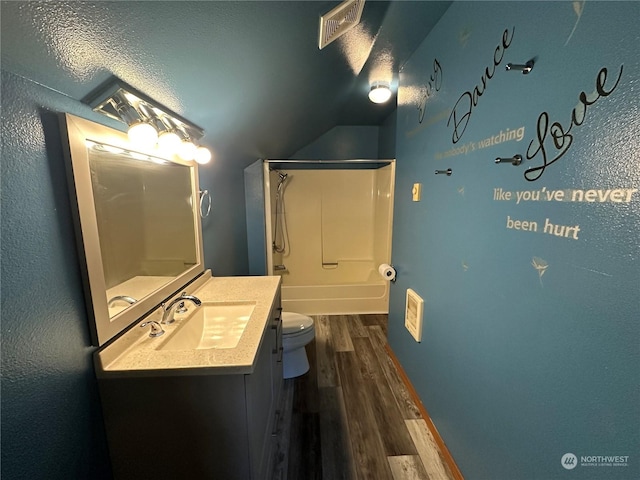 full bathroom featuring bathing tub / shower combination, hardwood / wood-style floors, vanity, and toilet