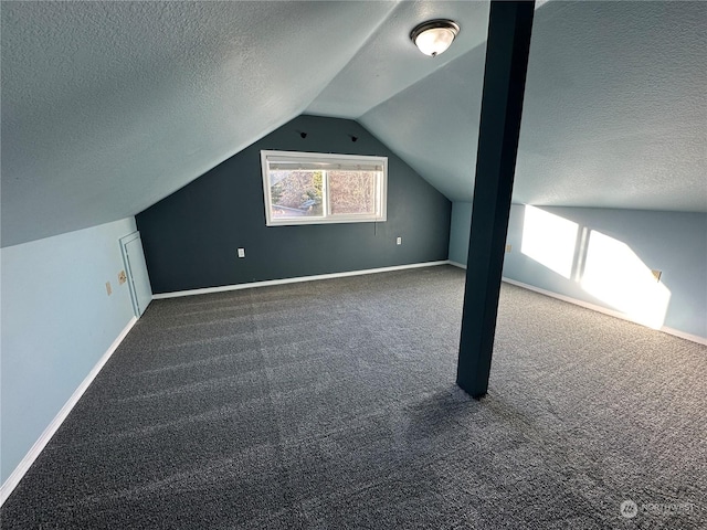 bonus room with lofted ceiling, carpet floors, and a textured ceiling