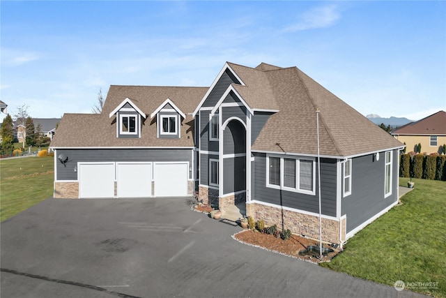 view of front of house with a garage and a front yard