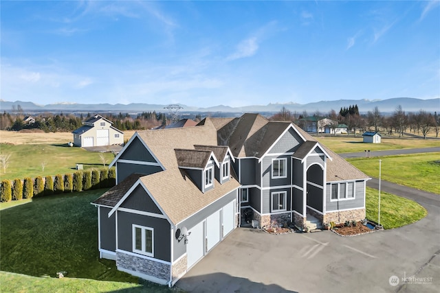 exterior space featuring a mountain view and a front lawn