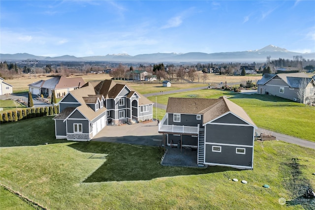 birds eye view of property with a mountain view