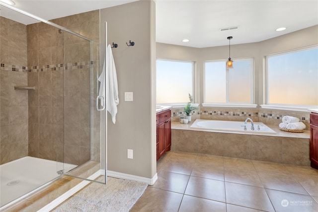 bathroom with independent shower and bath, vanity, and tile patterned floors