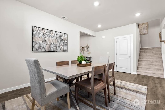 dining room with visible vents, stairs, wood finished floors, baseboards, and recessed lighting