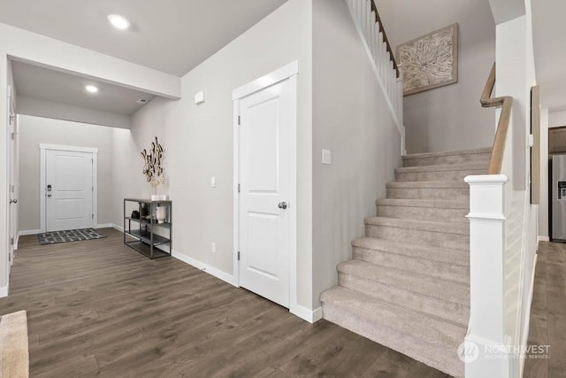stairs with baseboards, recessed lighting, and wood finished floors