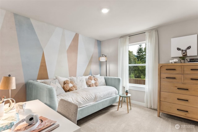 bedroom with baseboards and light colored carpet