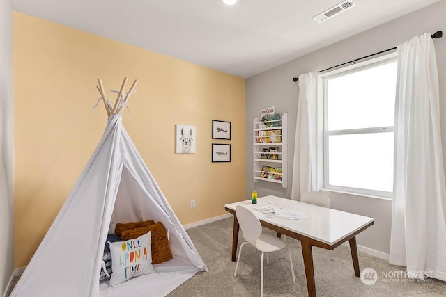 recreation room featuring light colored carpet