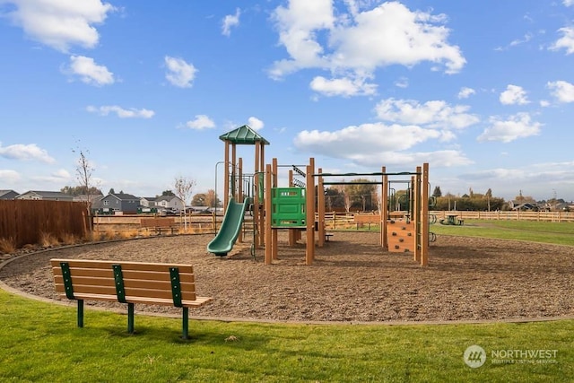 view of playground with a lawn