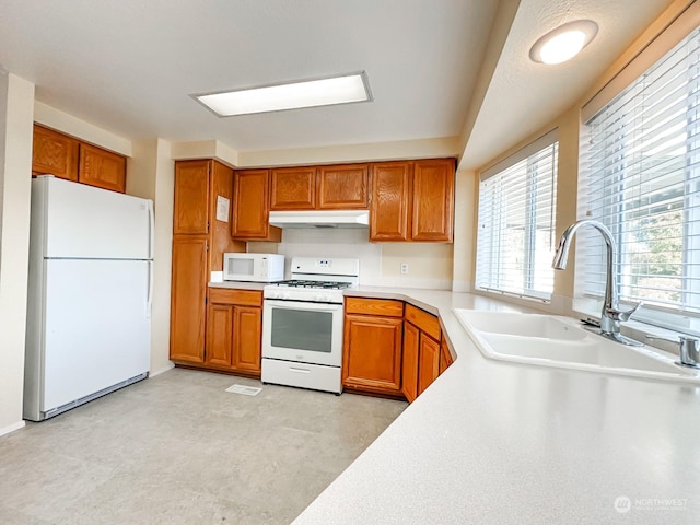 kitchen featuring white appliances and sink