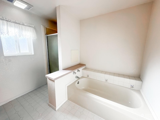 bathroom featuring shower with separate bathtub