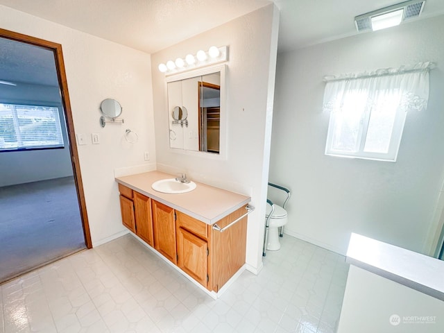 bathroom featuring vanity and toilet