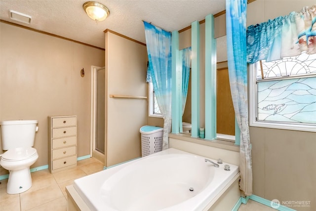 bathroom with plus walk in shower, toilet, crown molding, tile patterned floors, and a textured ceiling